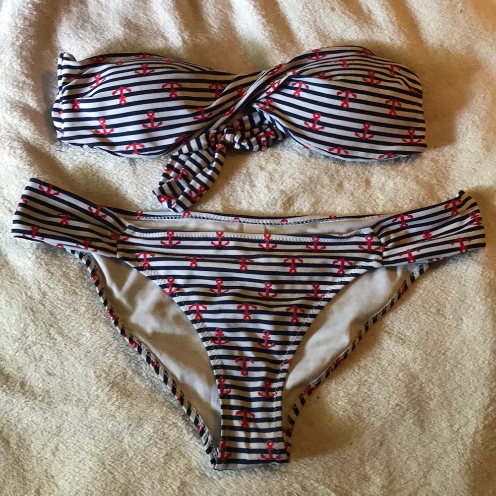 This is a swimsuit with anchors and stripes on it.